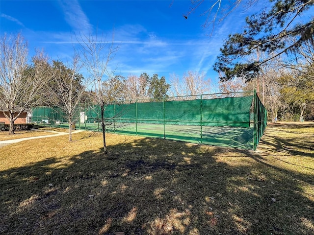 view of tennis court with a lawn