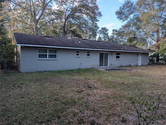 back of property featuring a lawn