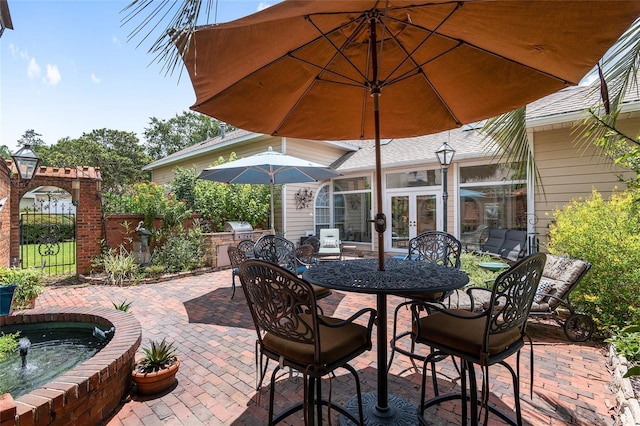 view of patio / terrace with french doors and exterior kitchen