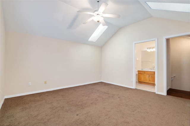 bonus room featuring vaulted ceiling with skylight, light carpet, and ceiling fan