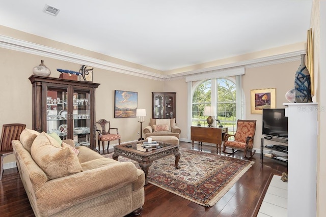 living room featuring hardwood / wood-style flooring and crown molding