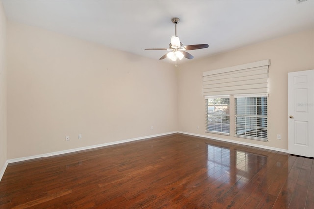 empty room with dark wood-type flooring and ceiling fan