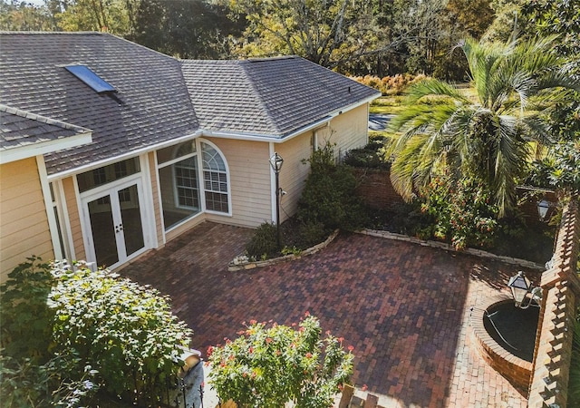 view of property exterior with french doors and a patio area