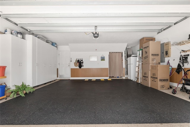 garage featuring a garage door opener and white fridge