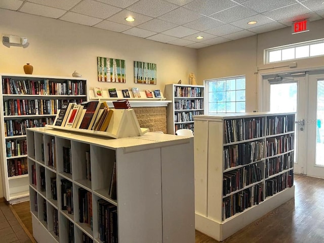 interior space with hardwood / wood-style flooring and a drop ceiling