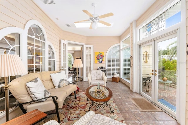 sunroom / solarium with ceiling fan and french doors