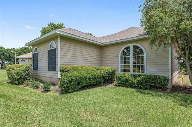 view of side of home with a lawn