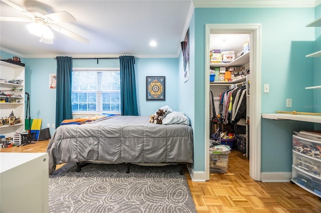 bedroom featuring a closet, a spacious closet, baseboards, and crown molding