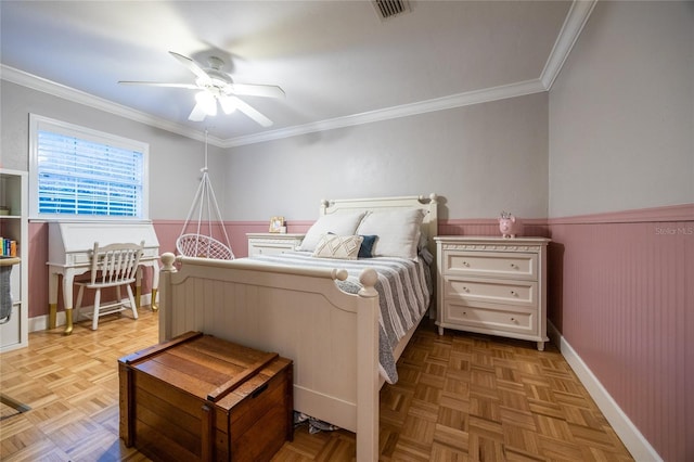 bedroom featuring ornamental molding, wainscoting, visible vents, and ceiling fan