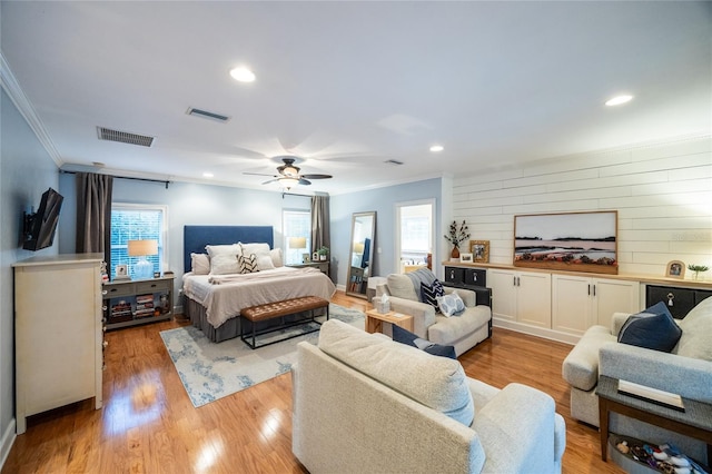 bedroom with light wood-type flooring, multiple windows, and visible vents