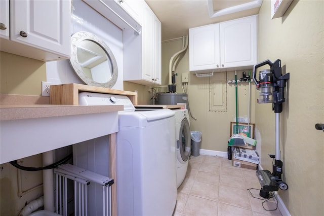 laundry area with cabinet space, separate washer and dryer, and light tile patterned flooring