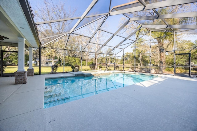 pool with glass enclosure and a patio