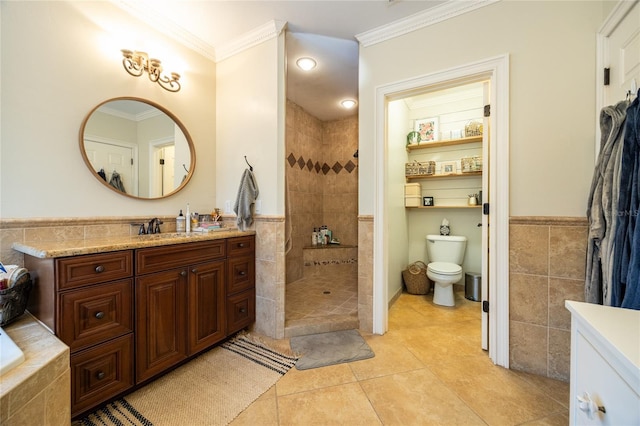 full bath featuring vanity, ornamental molding, walk in shower, and tile walls