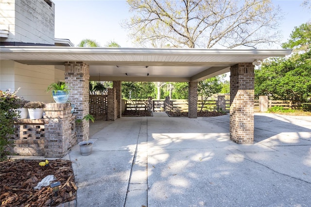 view of patio / terrace featuring a carport and concrete driveway