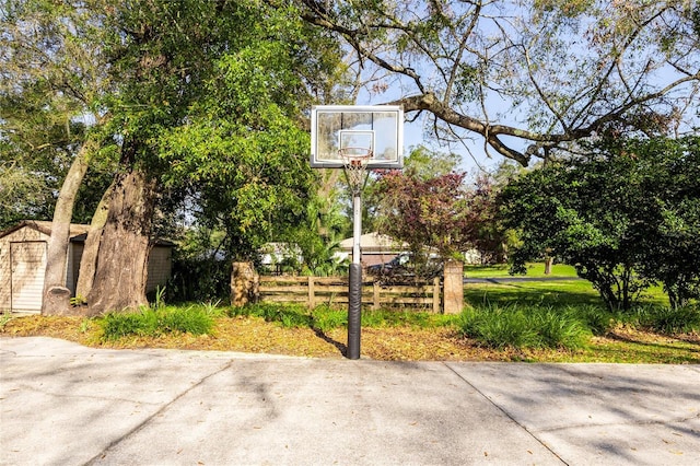 view of basketball court featuring a fenced front yard