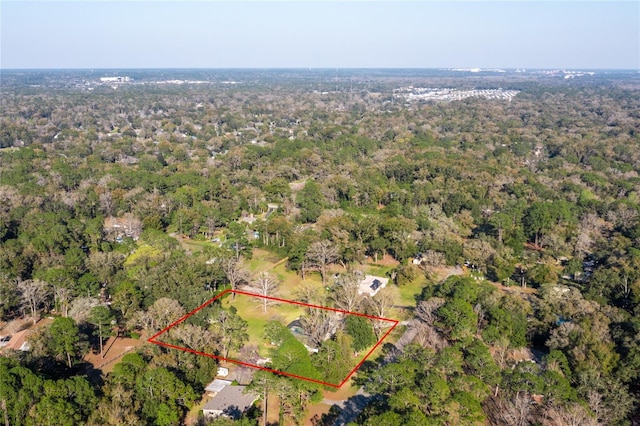 birds eye view of property featuring a view of trees