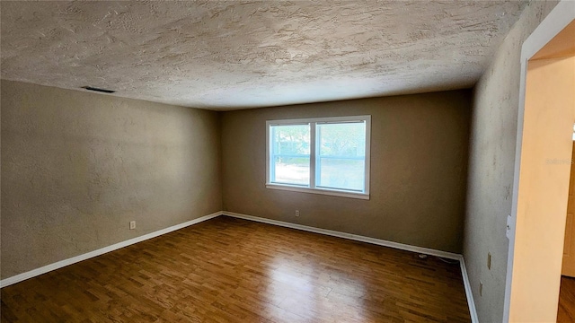 empty room with dark hardwood / wood-style floors