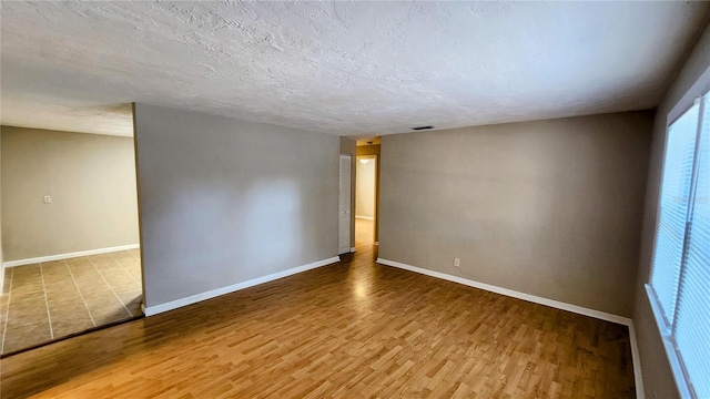 empty room featuring hardwood / wood-style floors and a textured ceiling