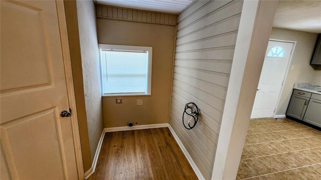 laundry room featuring plenty of natural light and wooden walls