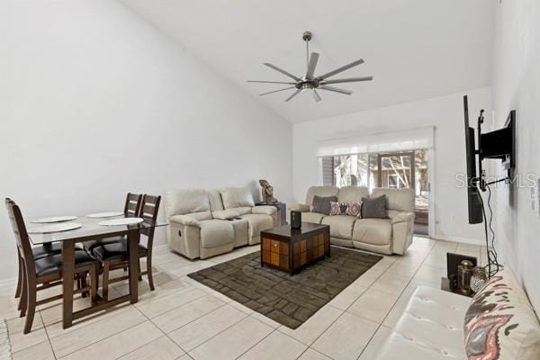 tiled living room featuring high vaulted ceiling and ceiling fan