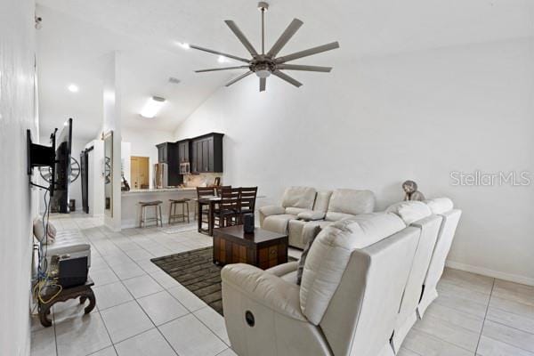 living room featuring vaulted ceiling and light tile patterned flooring