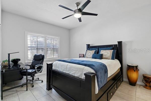 bedroom featuring light tile patterned floors and ceiling fan