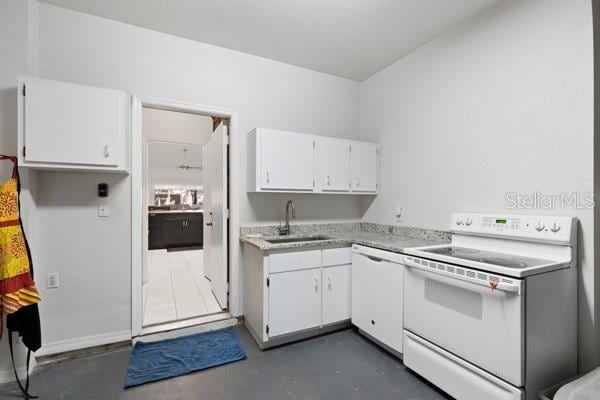 kitchen featuring white cabinetry, sink, and white appliances