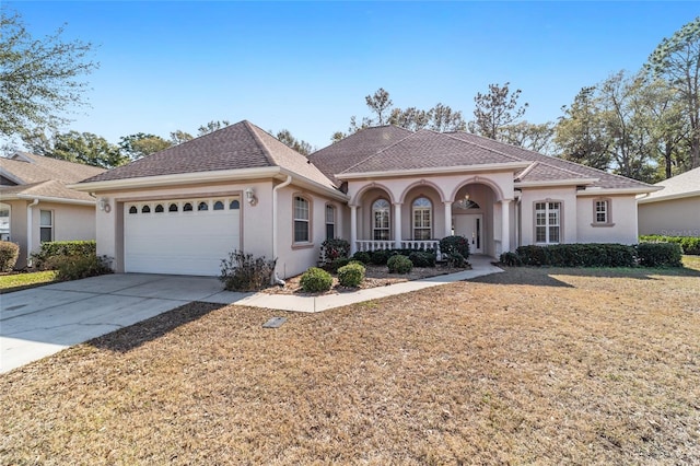 view of front facade featuring a porch and a garage