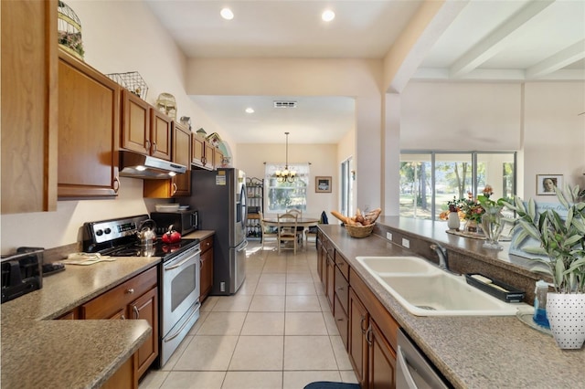 kitchen featuring light tile patterned flooring, sink, a notable chandelier, pendant lighting, and stainless steel appliances