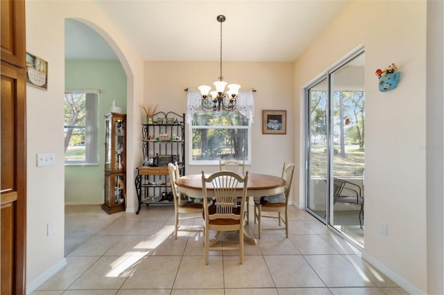 dining room with light tile patterned floors and a chandelier