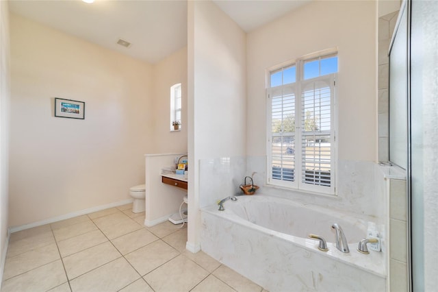 bathroom featuring toilet, tile patterned flooring, and a bathtub