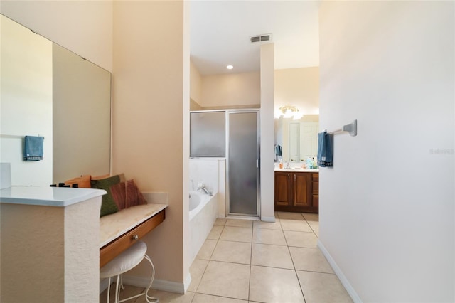 bathroom with vanity, shower with separate bathtub, and tile patterned floors