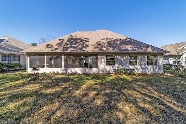 back of house with a lawn and a sunroom