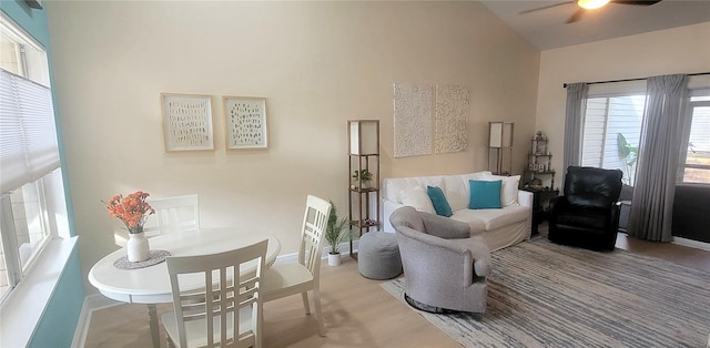 living area with vaulted ceiling and ceiling fan