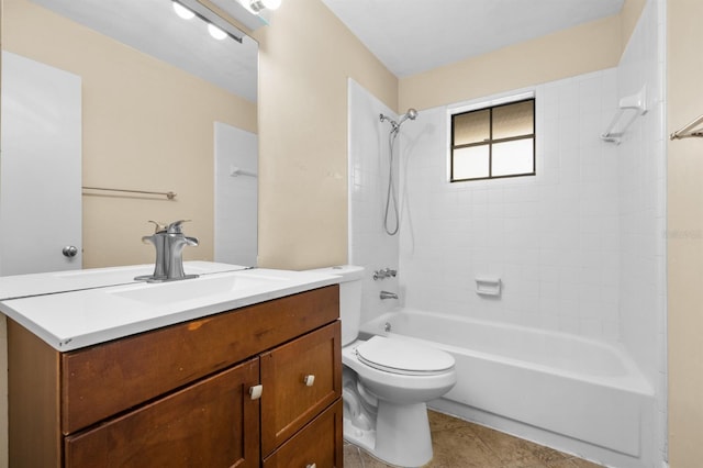 full bathroom with tile patterned flooring, vanity, tiled shower / bath, and toilet