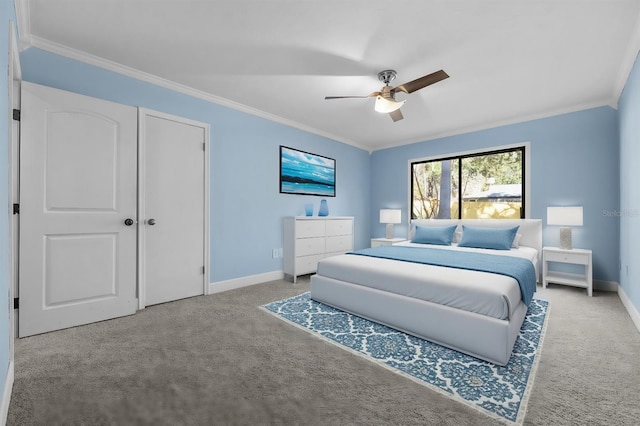 carpeted bedroom with crown molding and ceiling fan