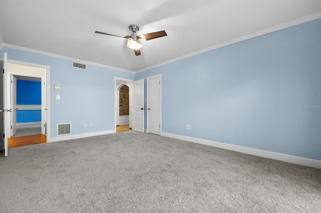 unfurnished bedroom featuring crown molding, ceiling fan, and carpet