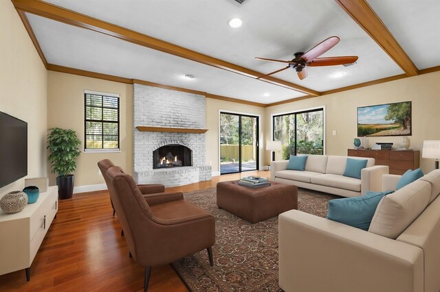 living room featuring a fireplace, beam ceiling, wood-type flooring, and a healthy amount of sunlight