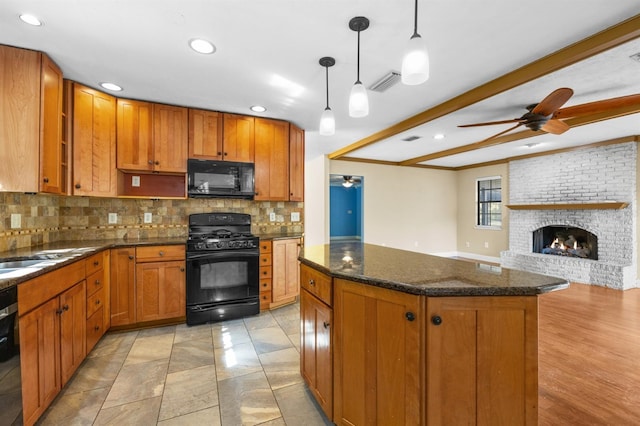 kitchen with tasteful backsplash, a kitchen island, pendant lighting, beam ceiling, and black appliances