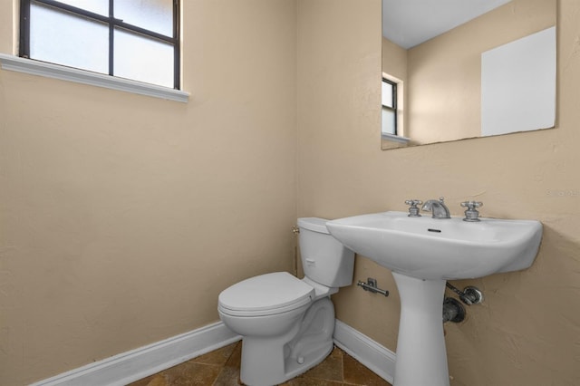 bathroom featuring tile patterned flooring and toilet