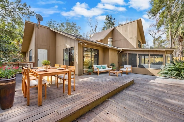 wooden deck with an outdoor living space and a sunroom