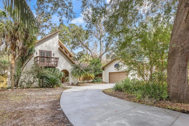 view of front of property with a balcony and a garage