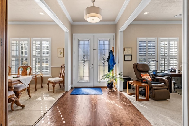 foyer entrance featuring hardwood / wood-style flooring and ornamental molding