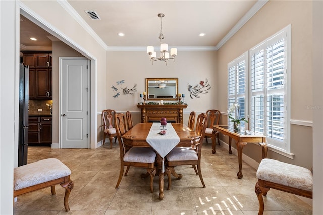 dining area with crown molding, light tile patterned floors, and a notable chandelier