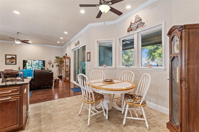 dining area featuring light tile patterned floors, crown molding, and ceiling fan