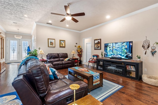 living room with ceiling fan, dark wood-type flooring, ornamental molding, and a textured ceiling