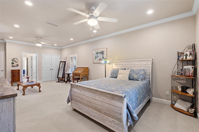 bedroom with crown molding, ceiling fan, a closet, and light carpet