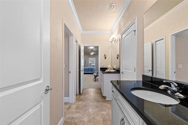 bathroom with tile patterned flooring, crown molding, vanity, and ceiling fan