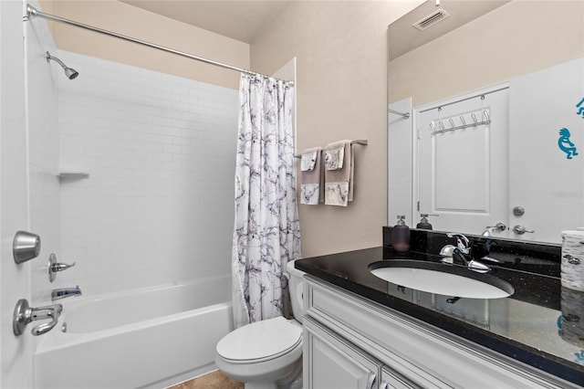 full bathroom with vanity, shower / bath combination with curtain, and toilet