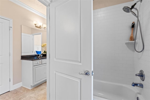 bathroom featuring tiled shower / bath combo, vanity, and crown molding